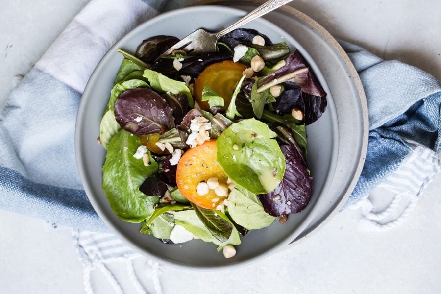 An overhead shot of beet salad in a grey bowl.