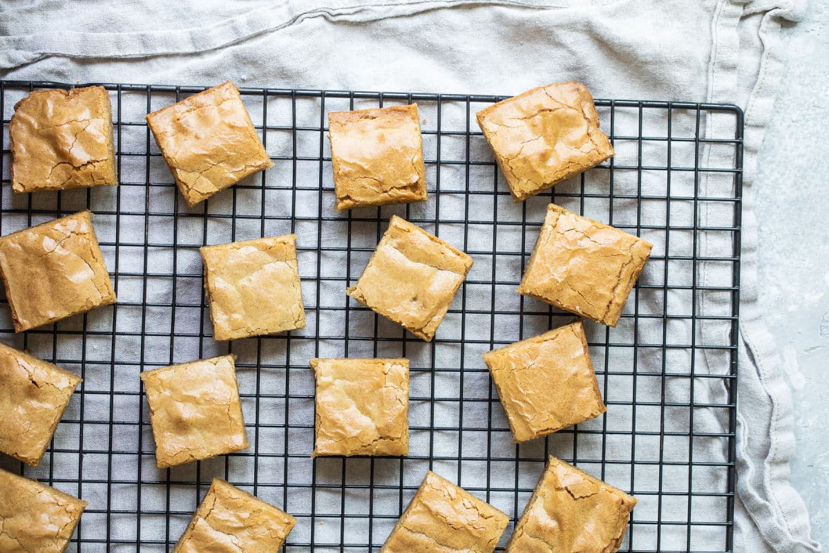 Square cut blondies on a cooling rack.