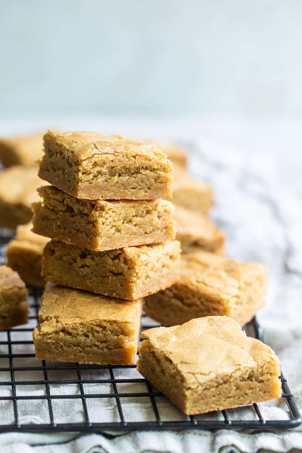 A stack of blondies on a cooling rack.