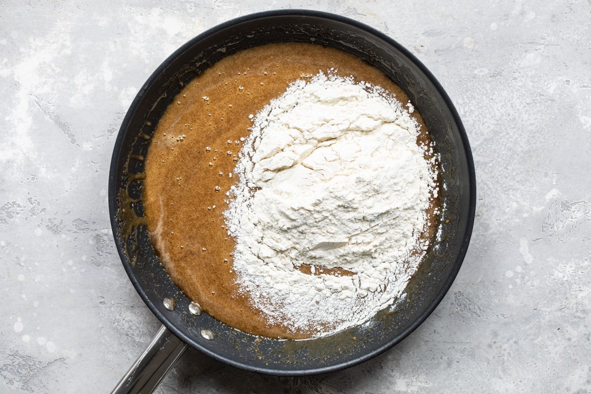 Flour being added to the brown sugar and butter mixture.
