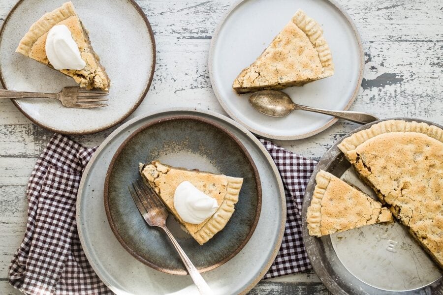 Slices of chocolate walnut pie on plates.
