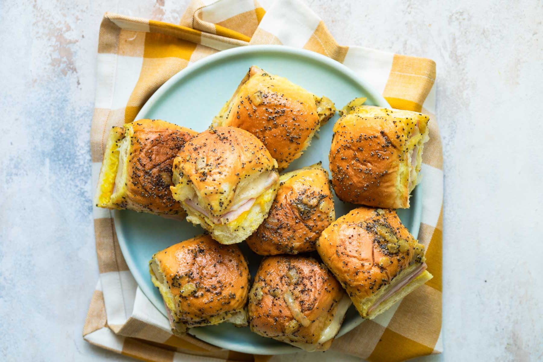 A plate of ham and cheese sliders.