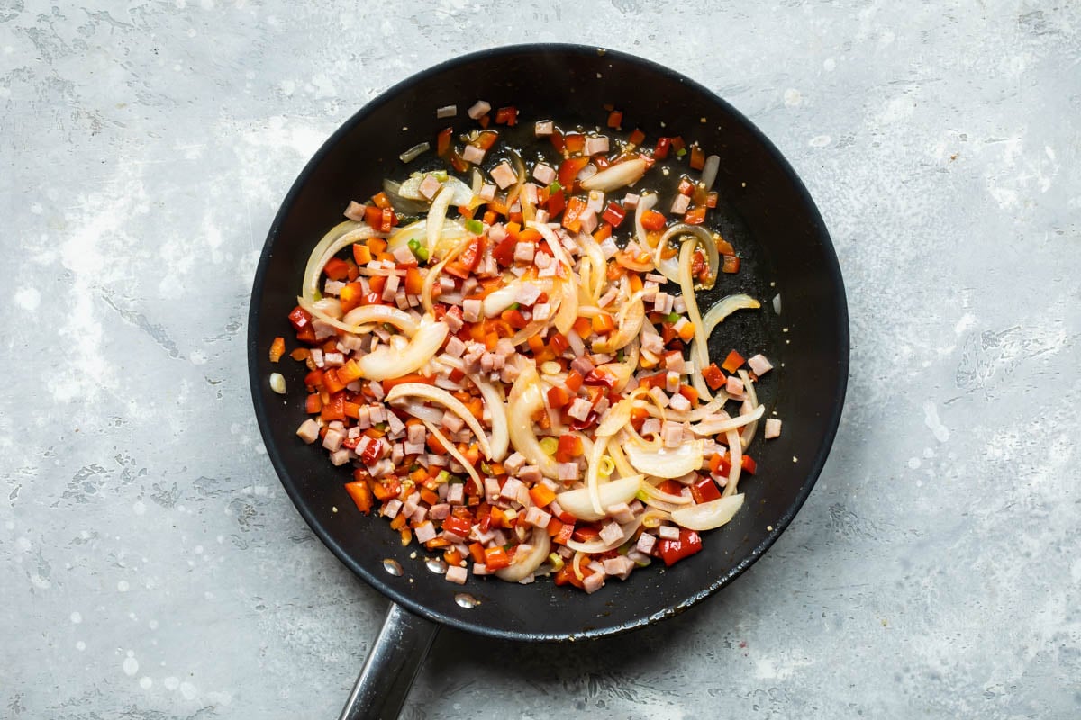 Vegetables cooking in a skillet.