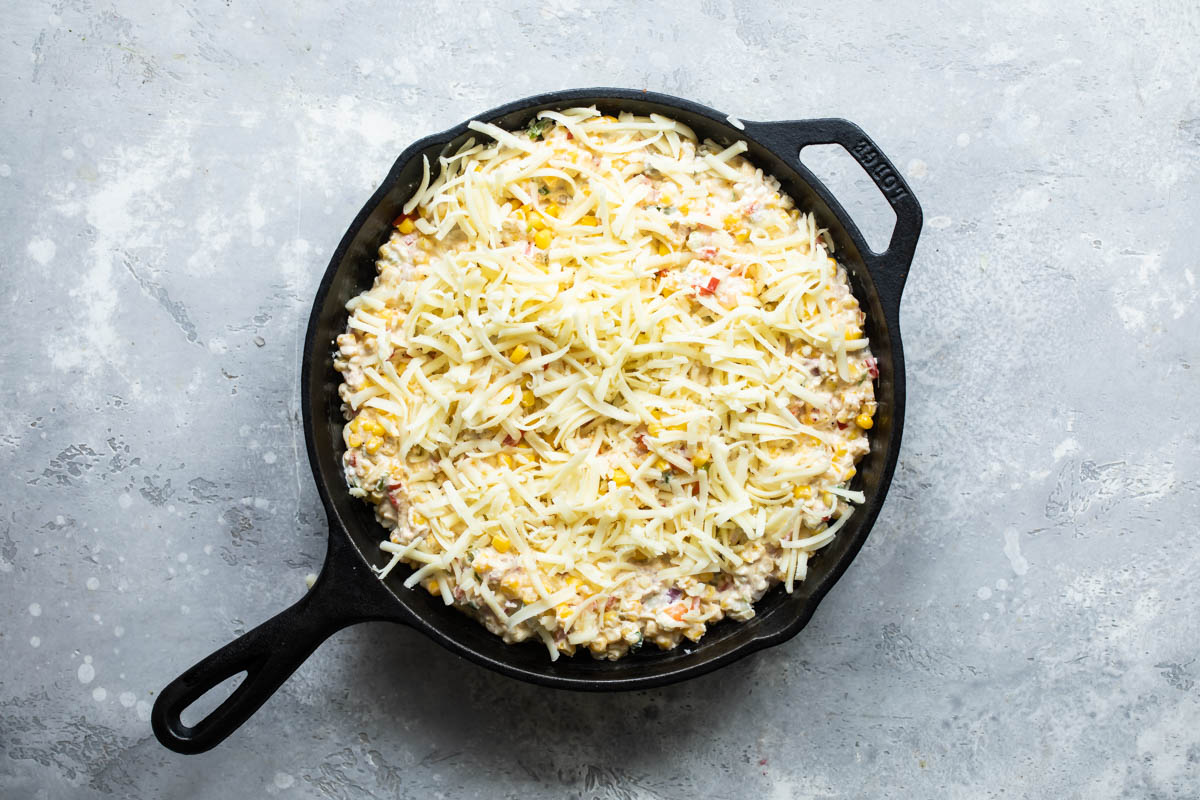 A skillet with hot corn dip (unbaked).