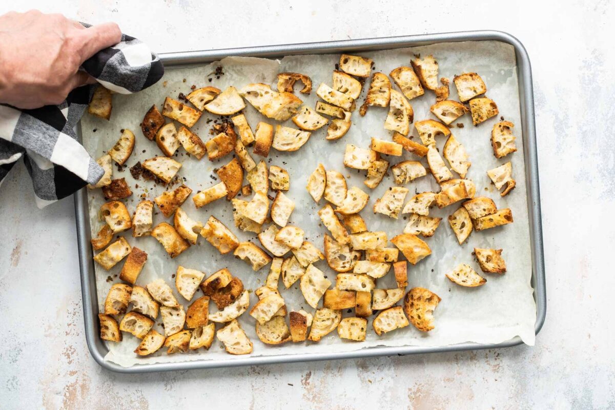 Croutons on a parchment lined baking sheet.