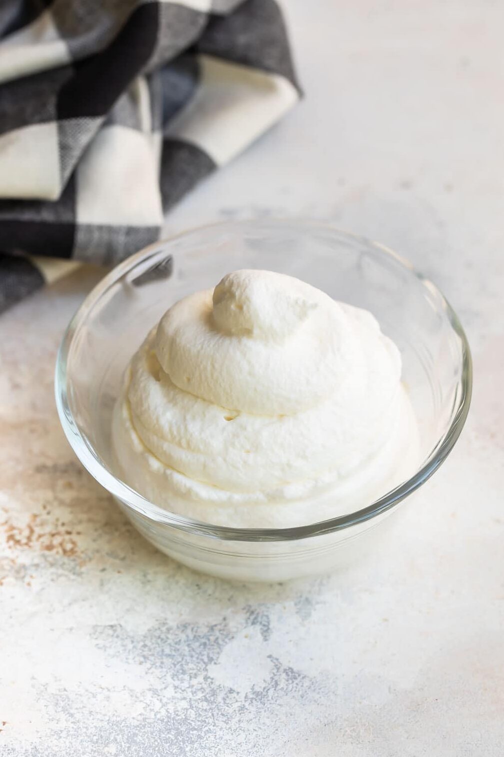 A bowl filled with piped whipped cream.