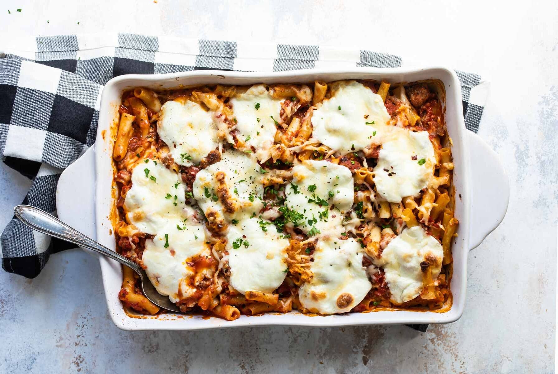 Baked ziti in a white baking dish.