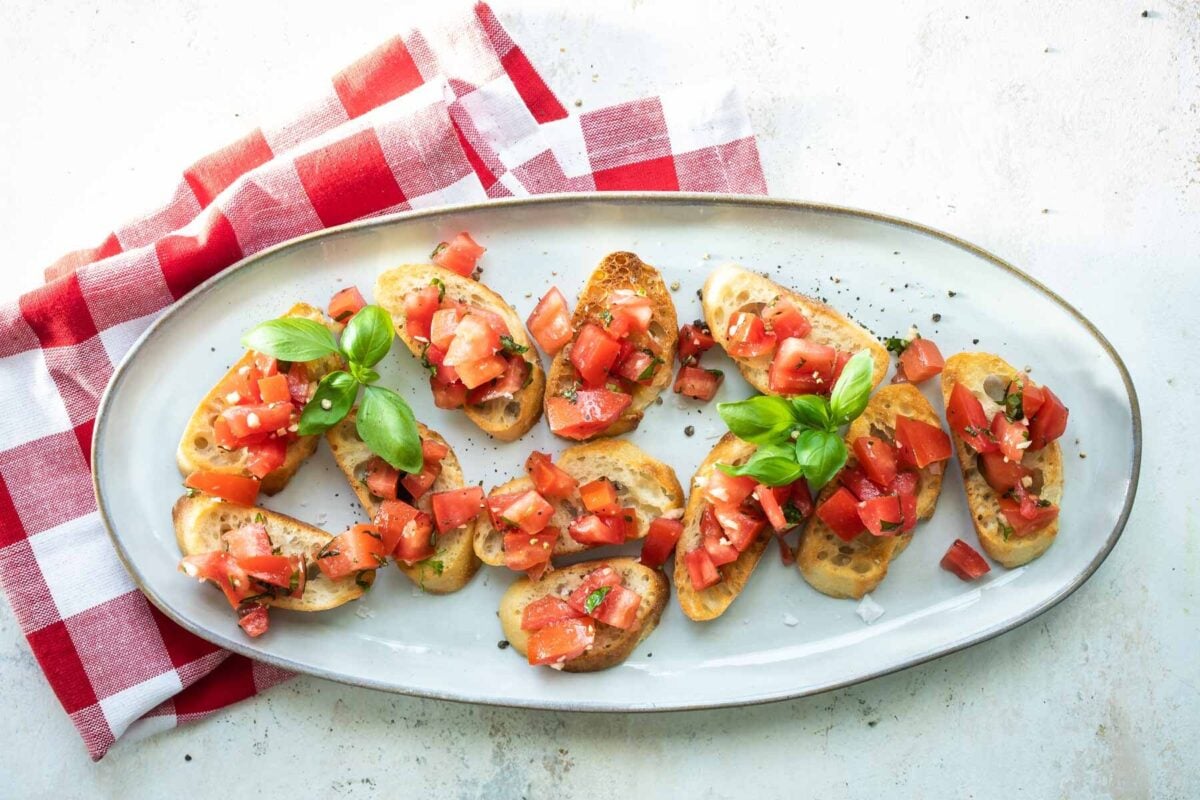Bruschetta on a white platter.