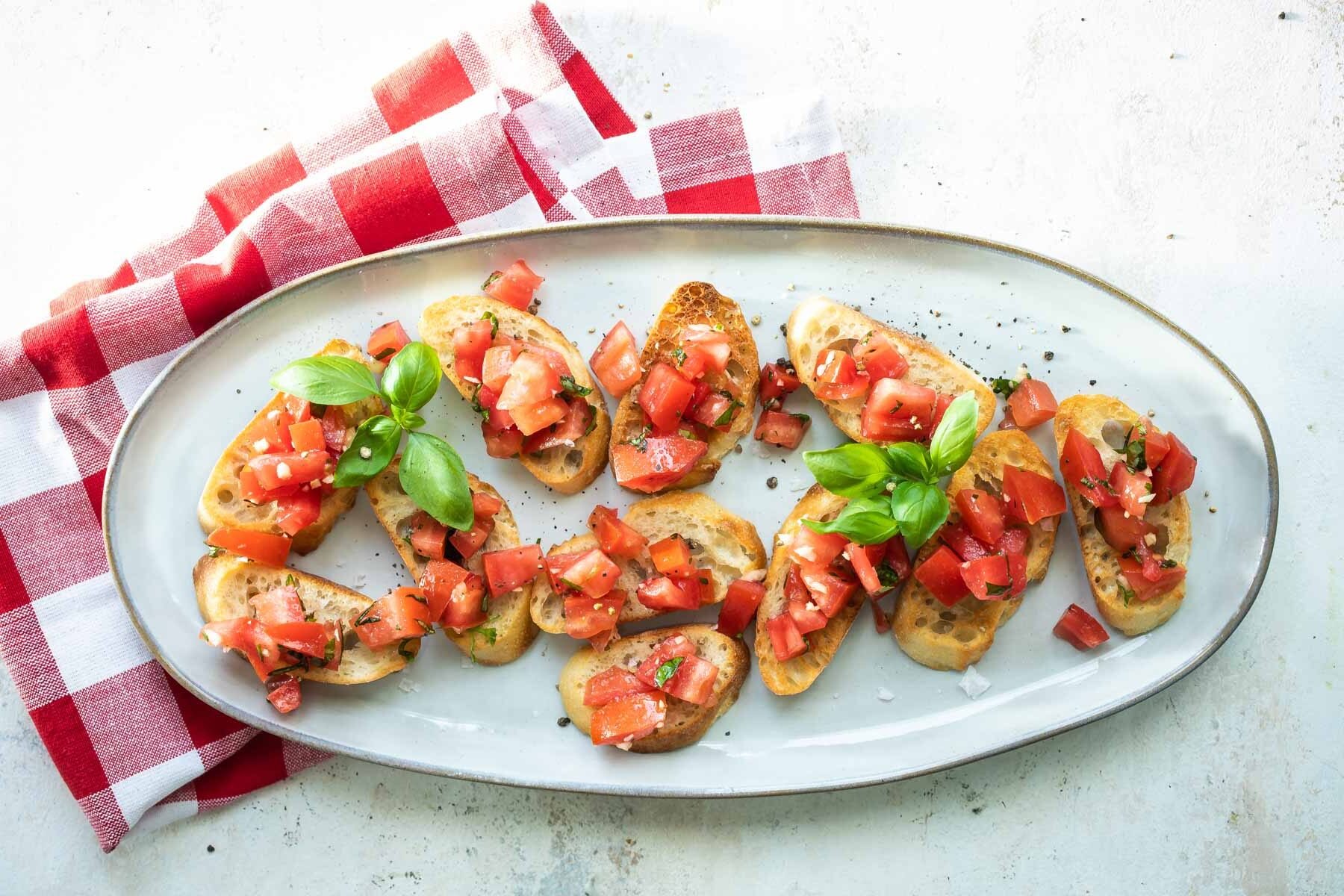 Bruschetta on a white platter.