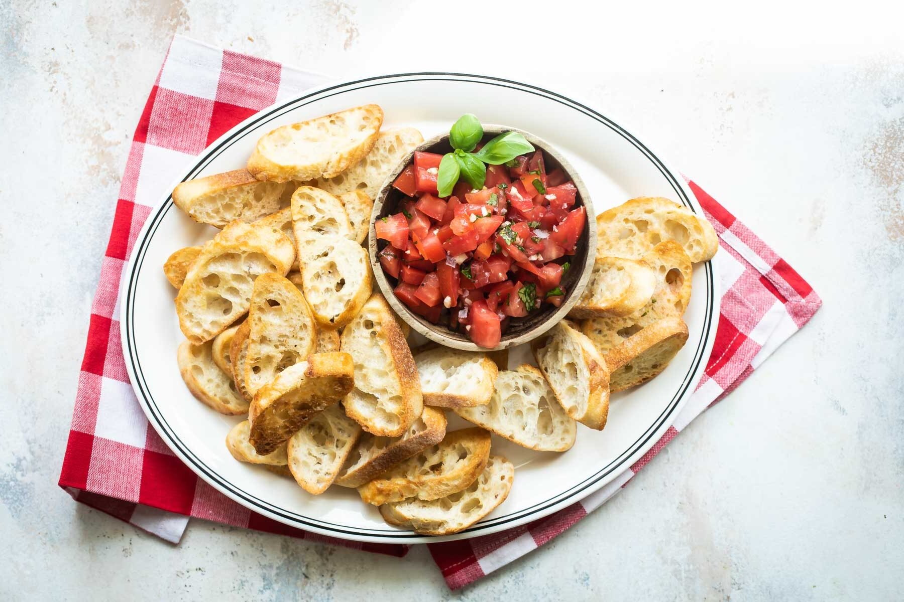 Bruschetta on a white platter.