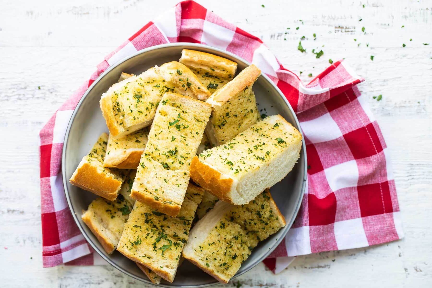 Garlic bread slices in a gray bowl.