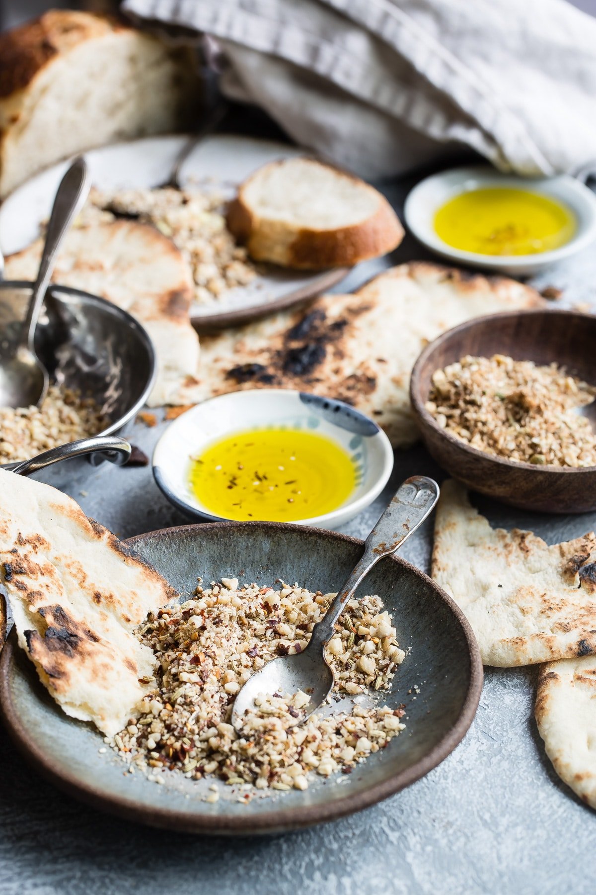 Dukkah on a blue plate with pita bread.