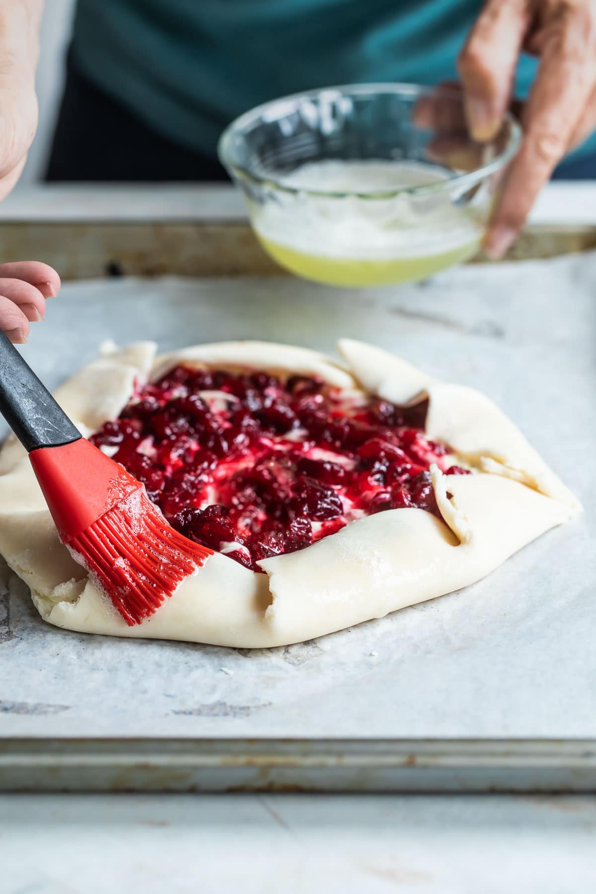 Brushing egg wash on a galette.
