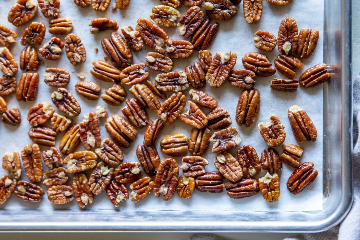 Toasted pecans on a baking sheet.