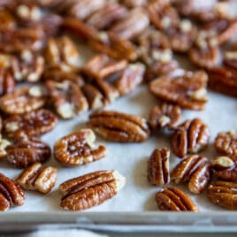 Toasted pecans on a baking sheet.