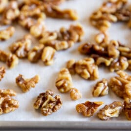 Toasted walnuts on a baking sheet.