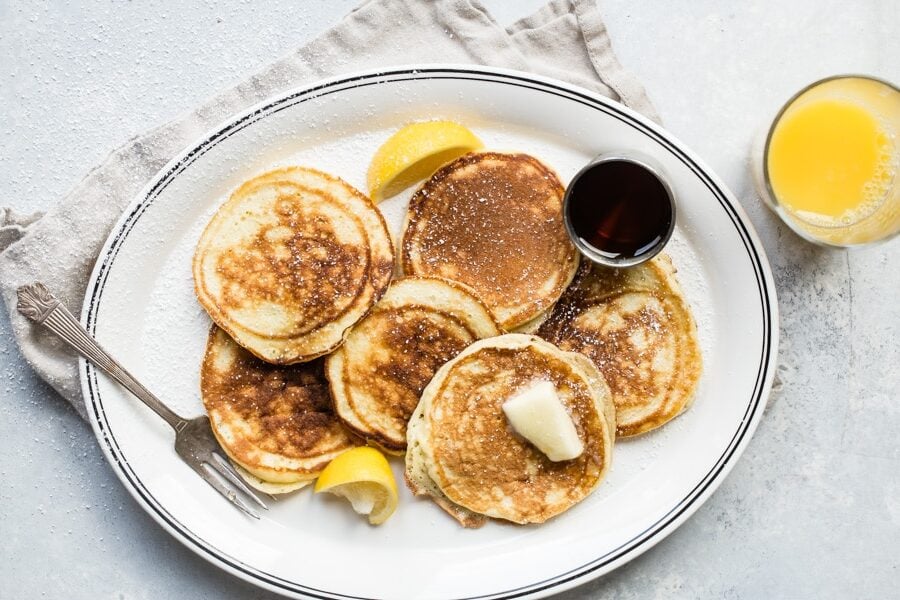 A stack of lemon ricotta pancakes on a plate.