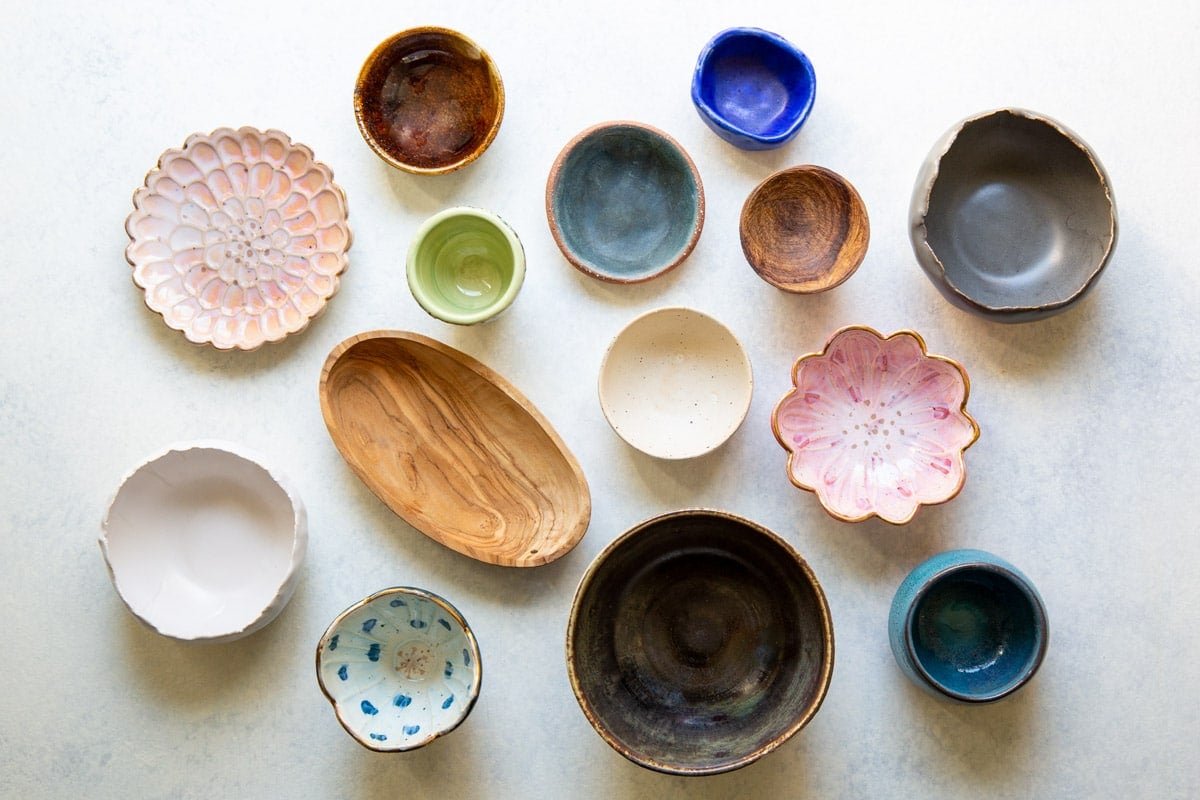 A collection of bowls and dishes for charcuterie display.