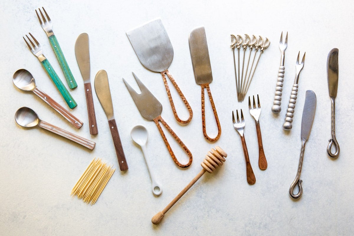 A collection of tools and utensils for charcuterie display.
