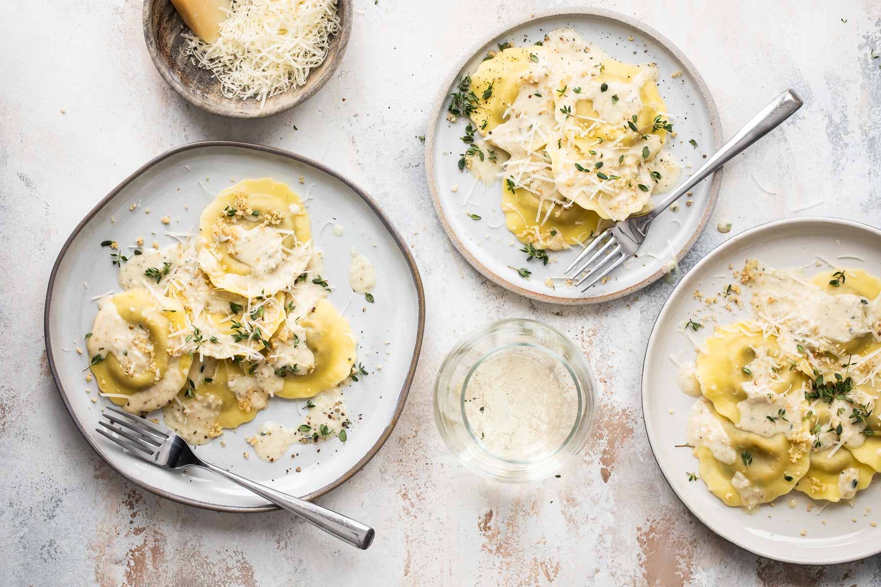 Three plates of mushroom ravioli.