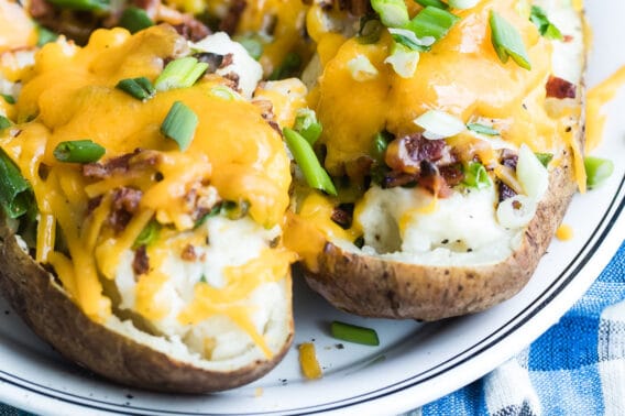 Twice baked potatoes on a white platter.