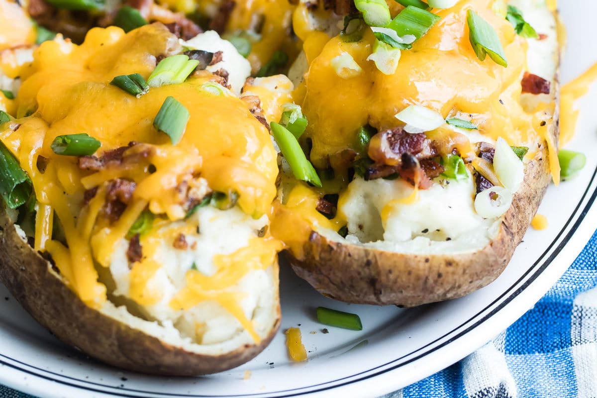 Twice baked potatoes on a white platter.