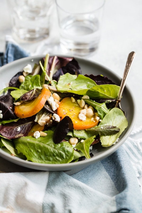 Beet salad in a grey bowl.