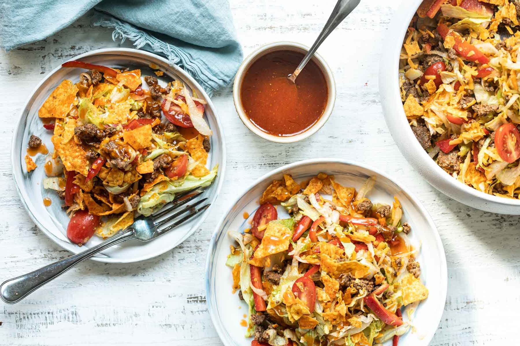 Two bowls filled with Dorito Taco Salad.