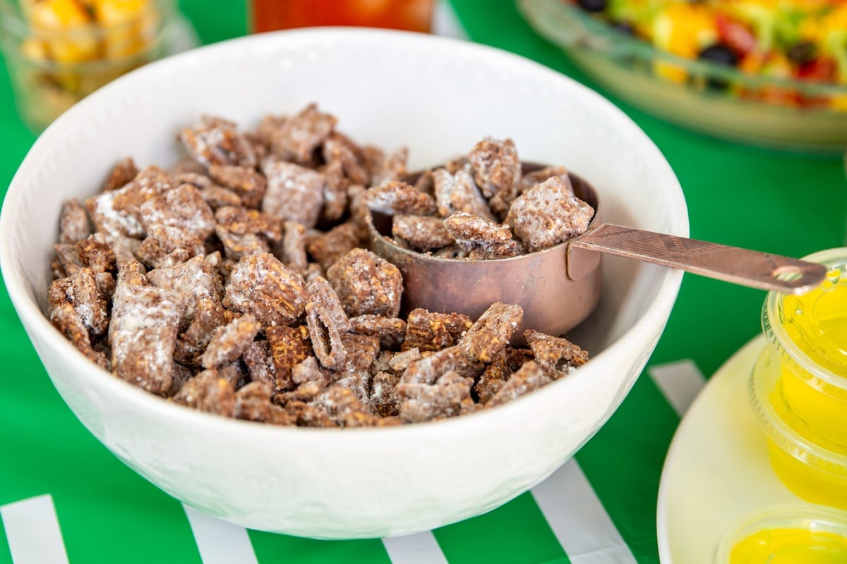 A bowl of puppy chow in a football-themed table.