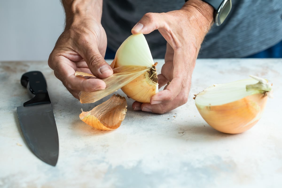 Peeling half an onion.