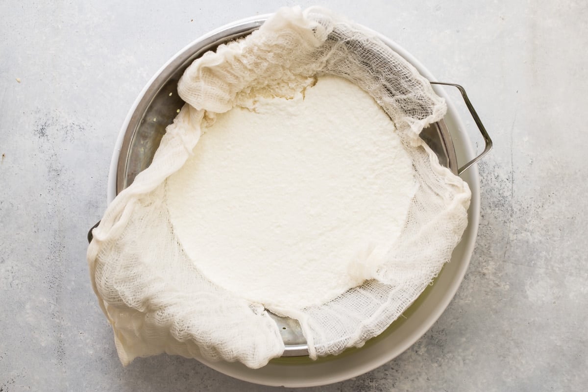 Ricotta cheese being strained.