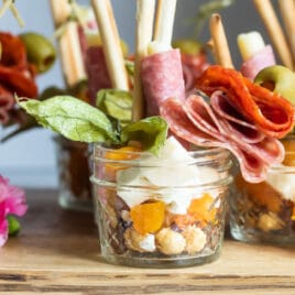Jarcuteries on a wooden cutting board.