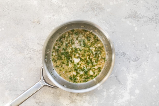 Lemon butter sauce in a skillet.