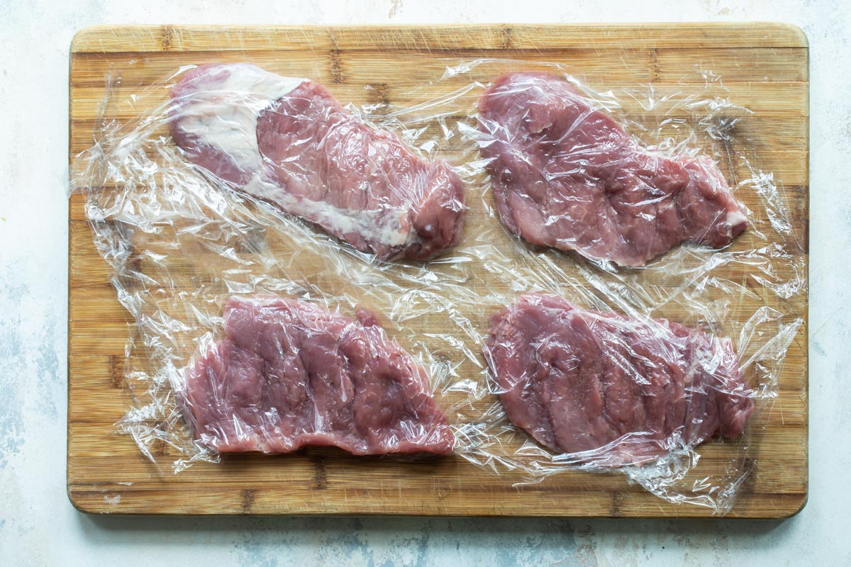 Pounding pork cutlets thinly for schnitzel.