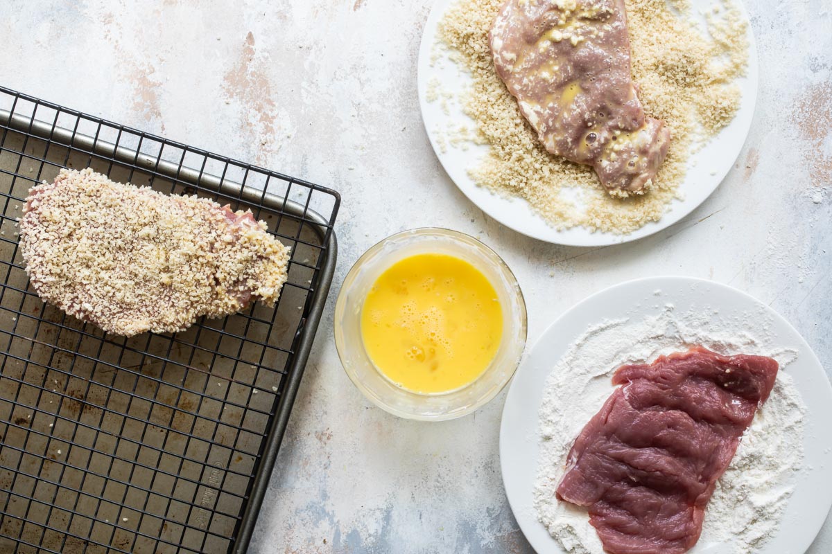 Breading pork cutlets for schnitzel.