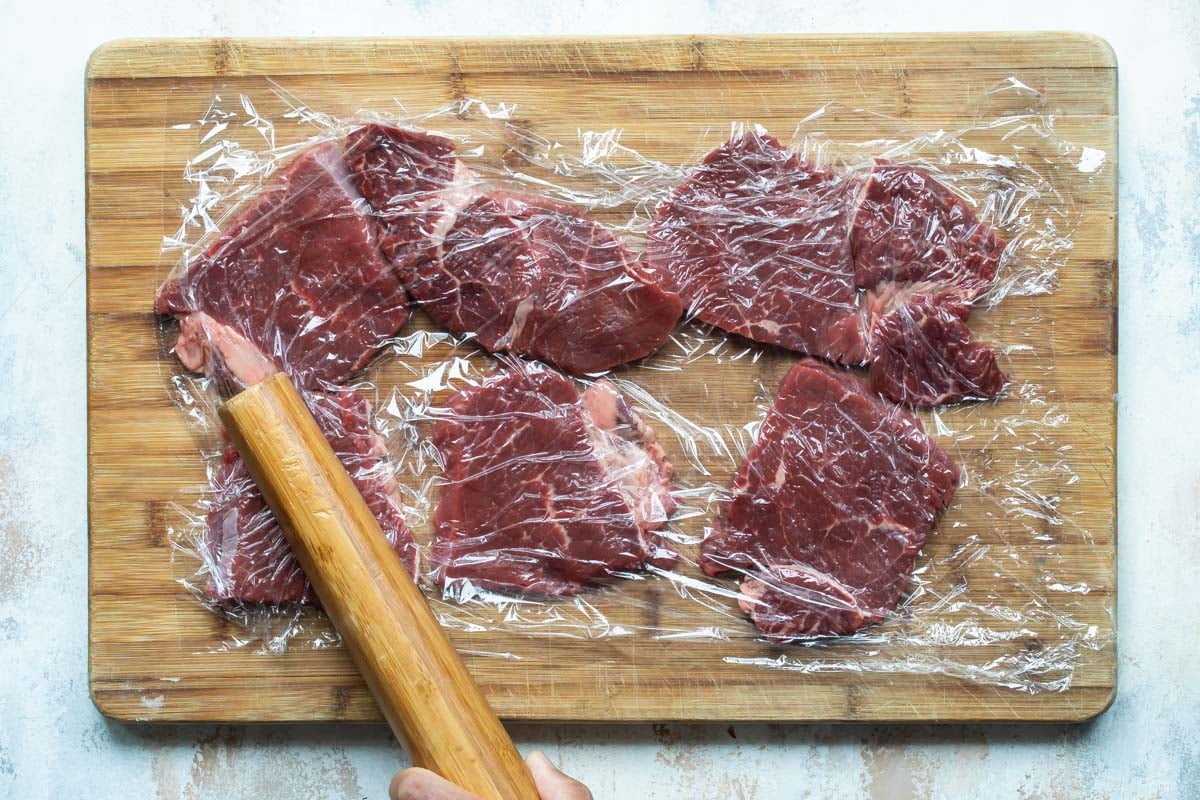 Pounding beef thin to make rouladen.