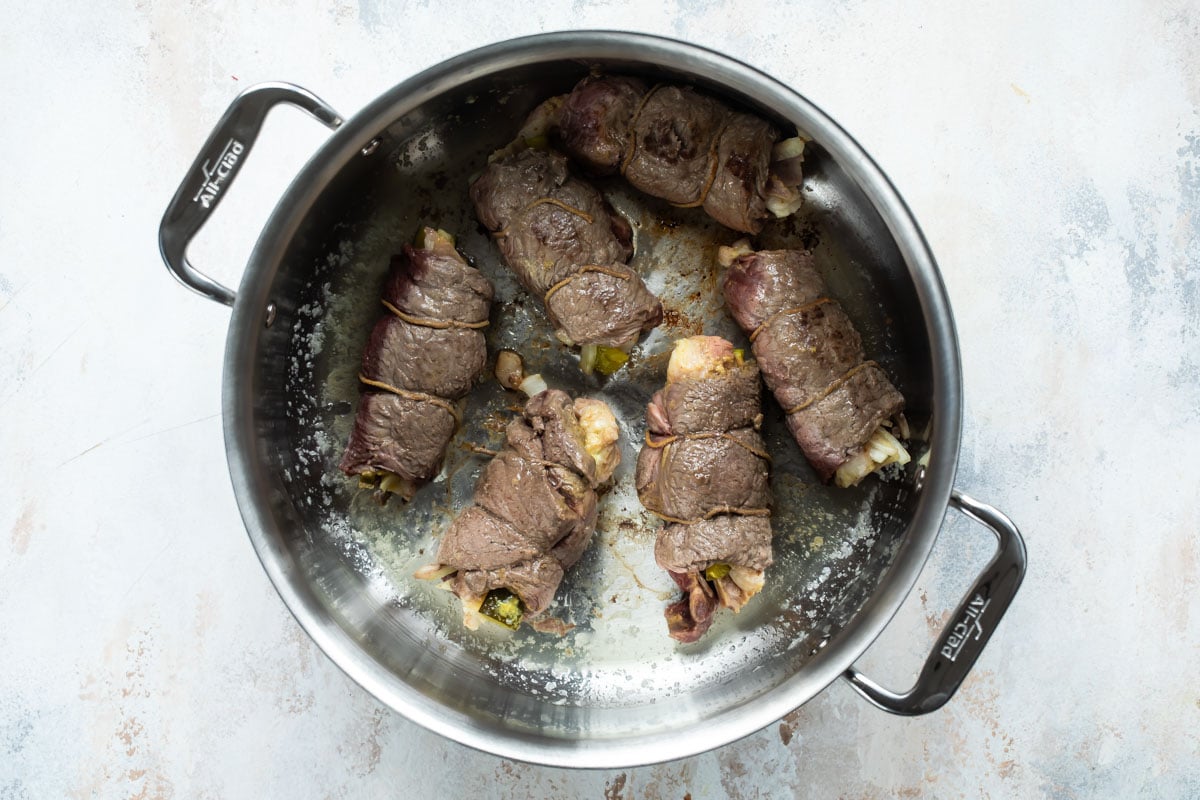 Rouladen in a saucepan.