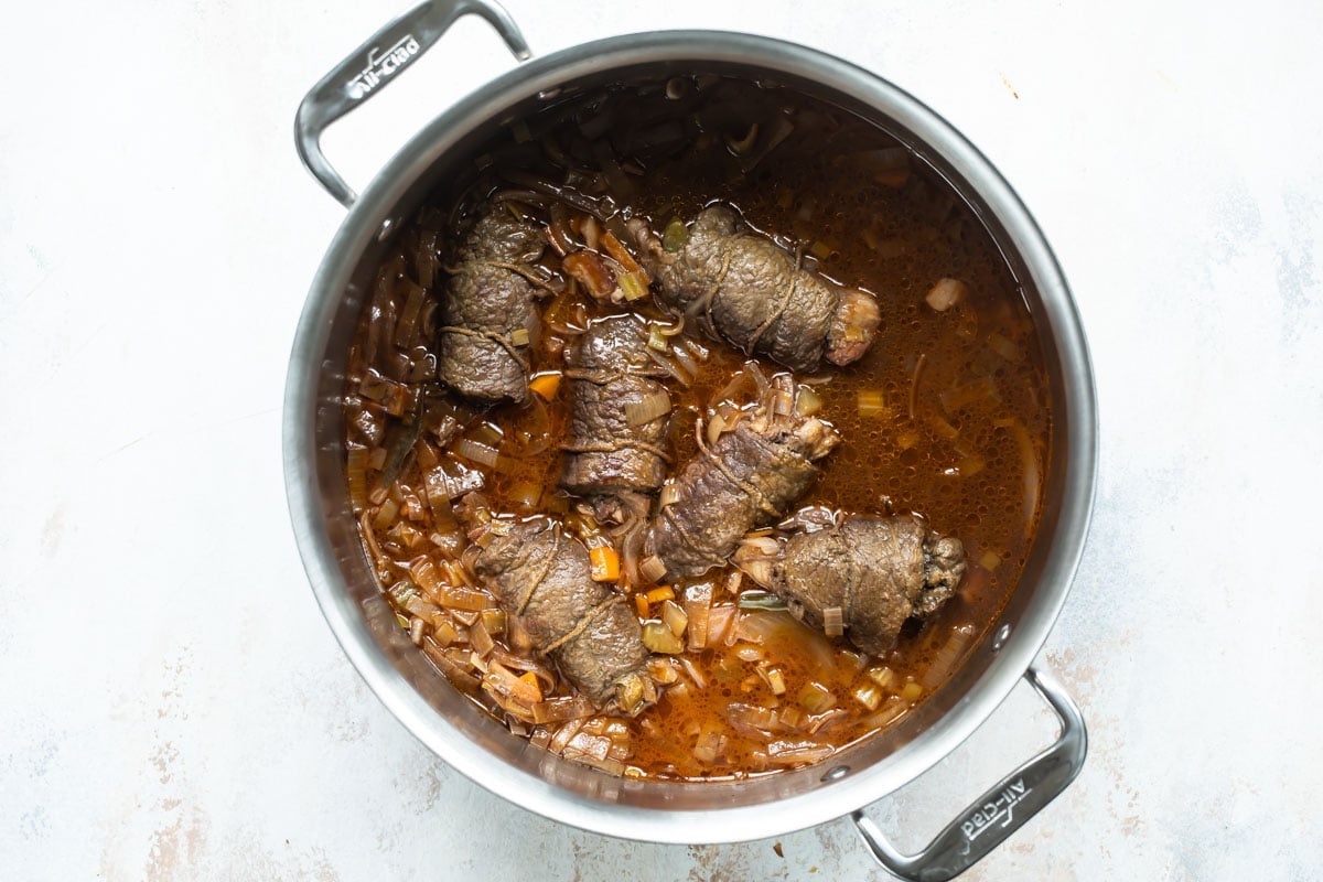 Rouladen in a saucepan.