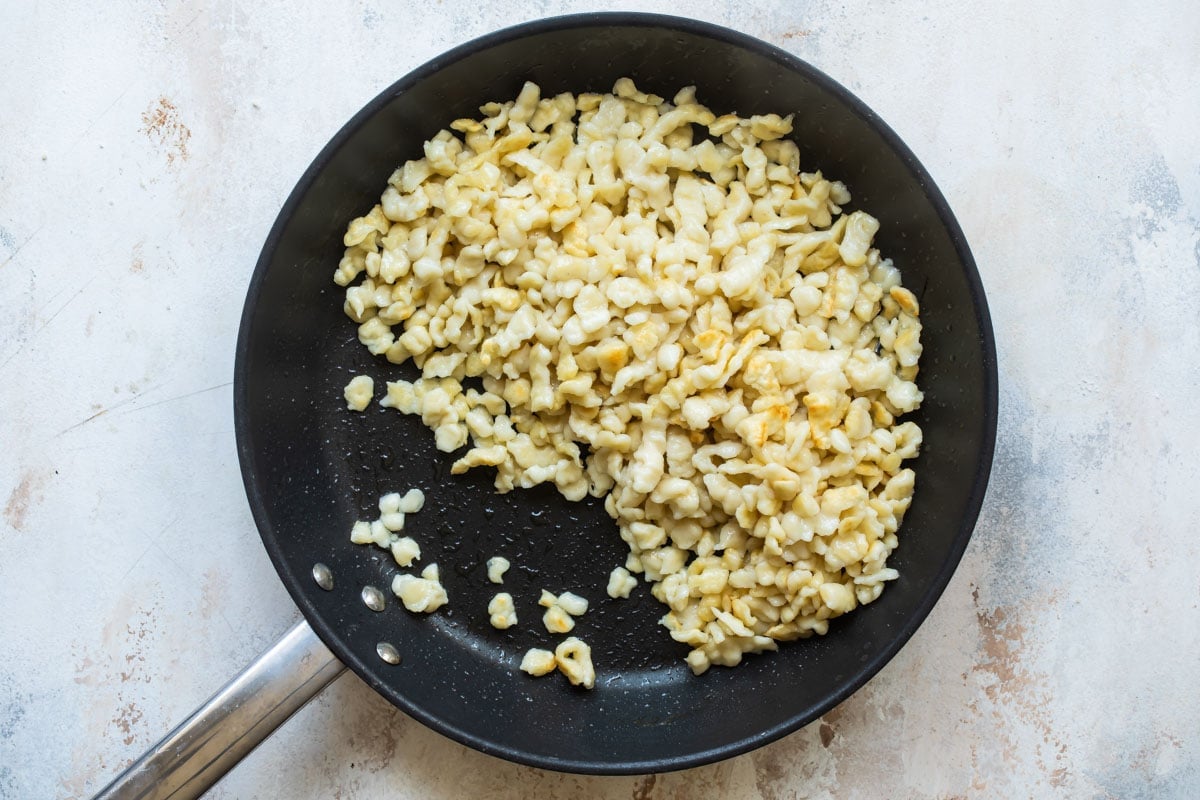 Sauteing spaetzle in a pan.