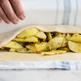 Strudel dough wrapped around an apple filling for Apple Strudel.