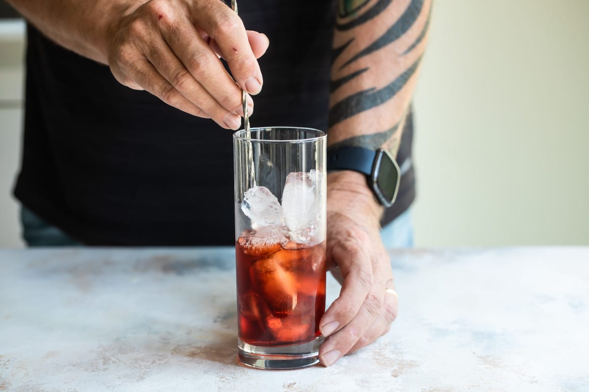 Someone stirring an Americano.