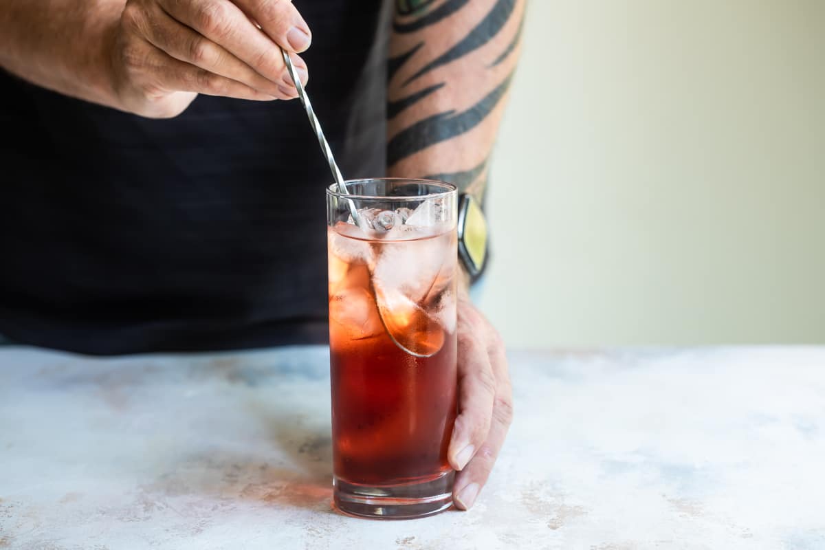 Someone stirring an Americano.