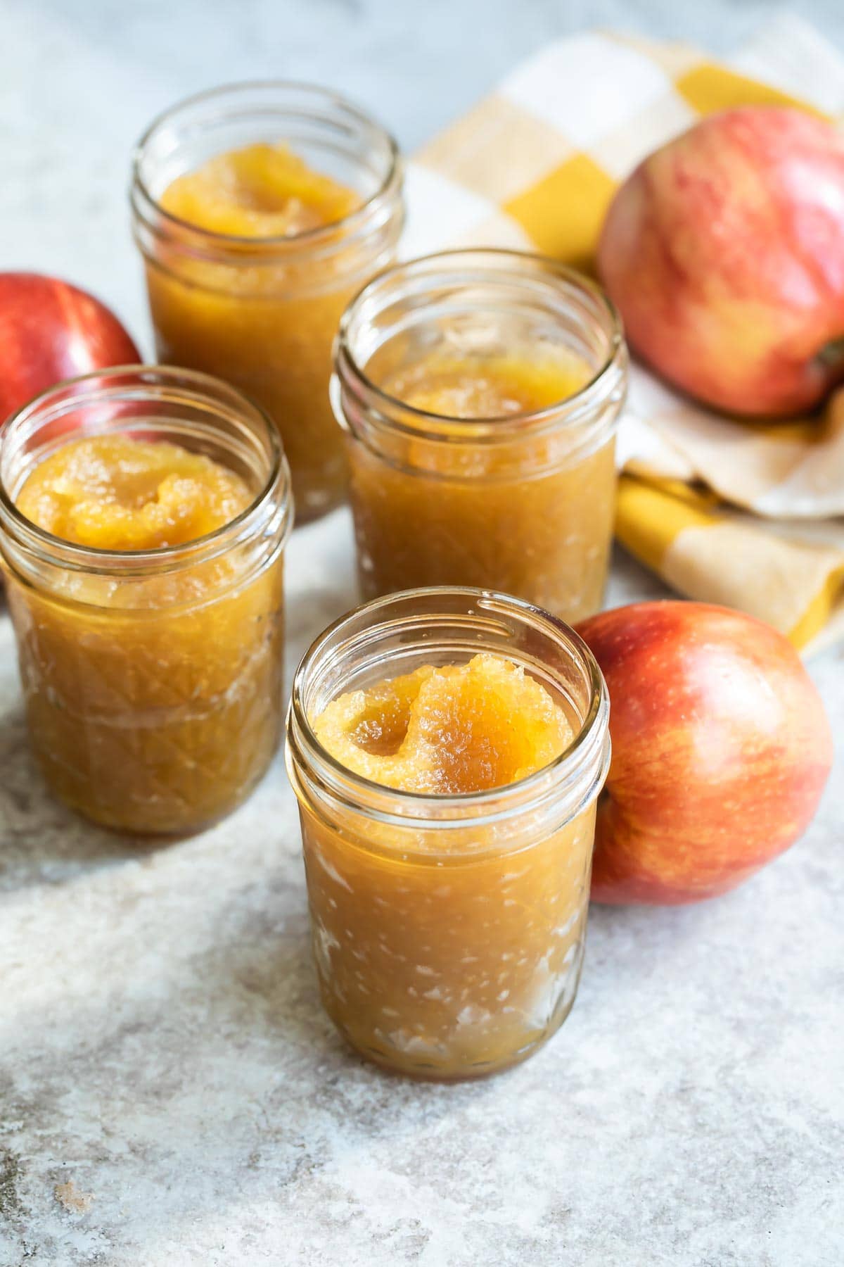Apple butter in four mason jars.