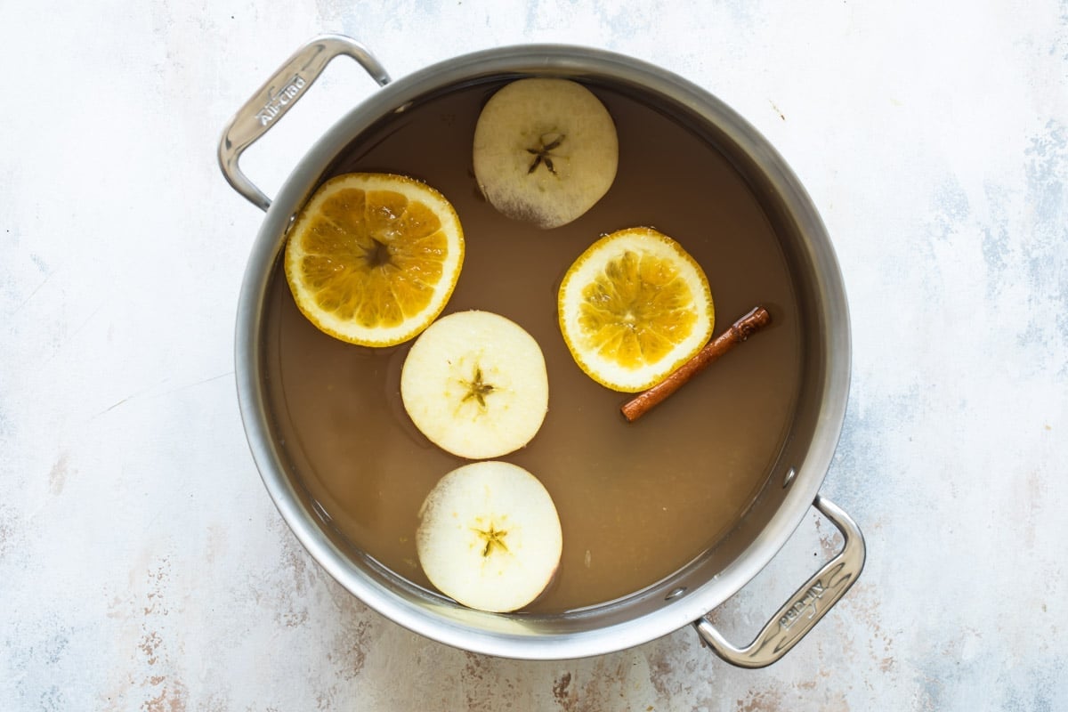 Apple cider in a stock pot.