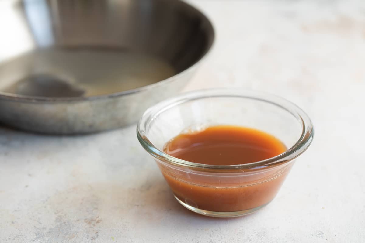 A brown liquid in a ramekin.