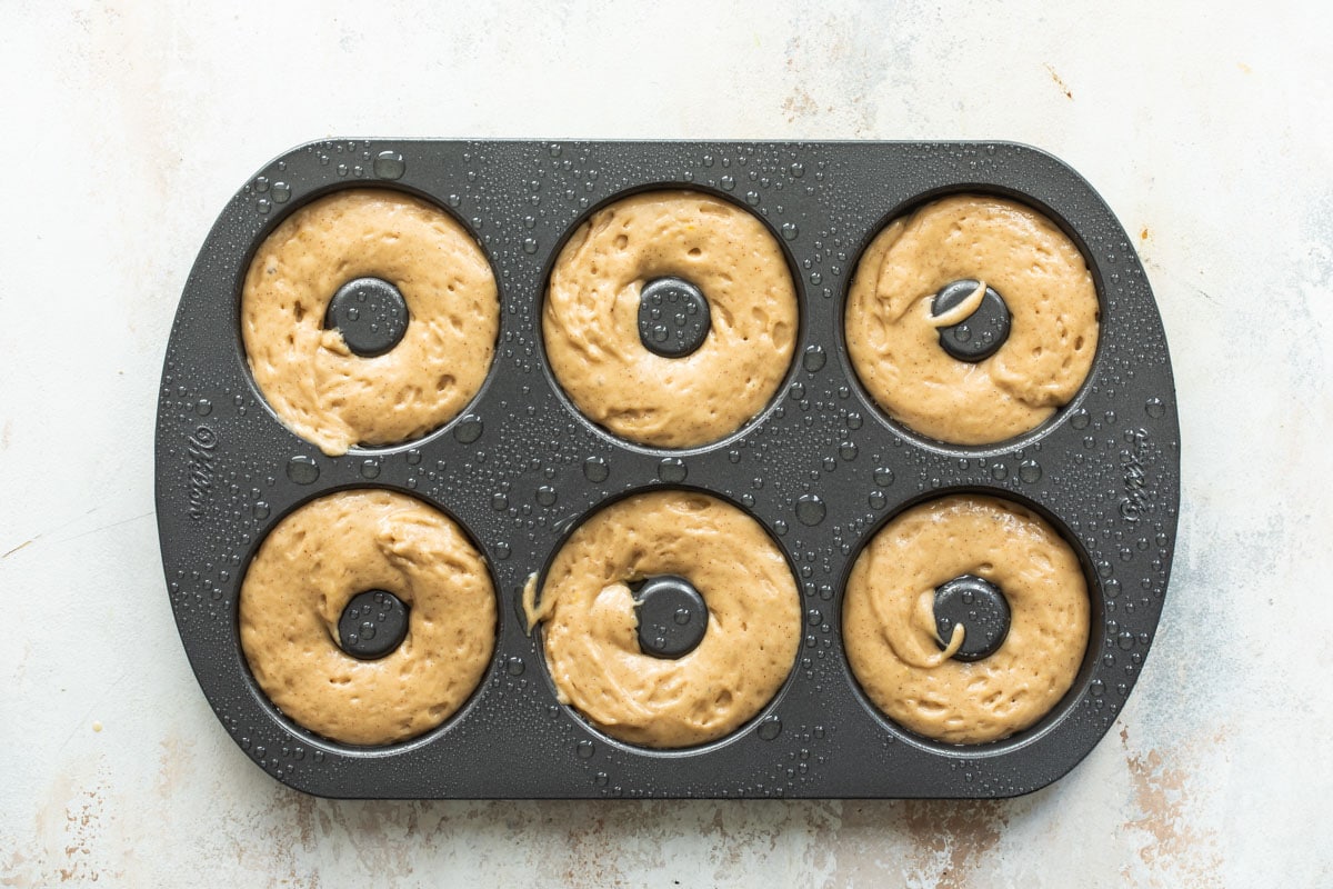 Donut batter for six donuts in a donut pan.