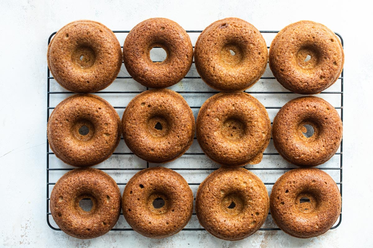 Apple cider donuts on a wire cooling rack.