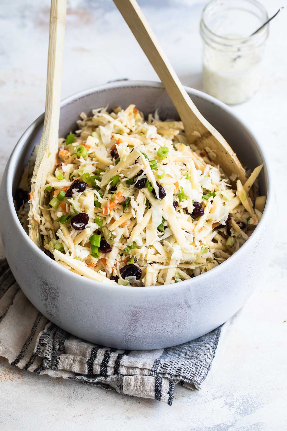 A serving bowl filled with apple coleslaw.