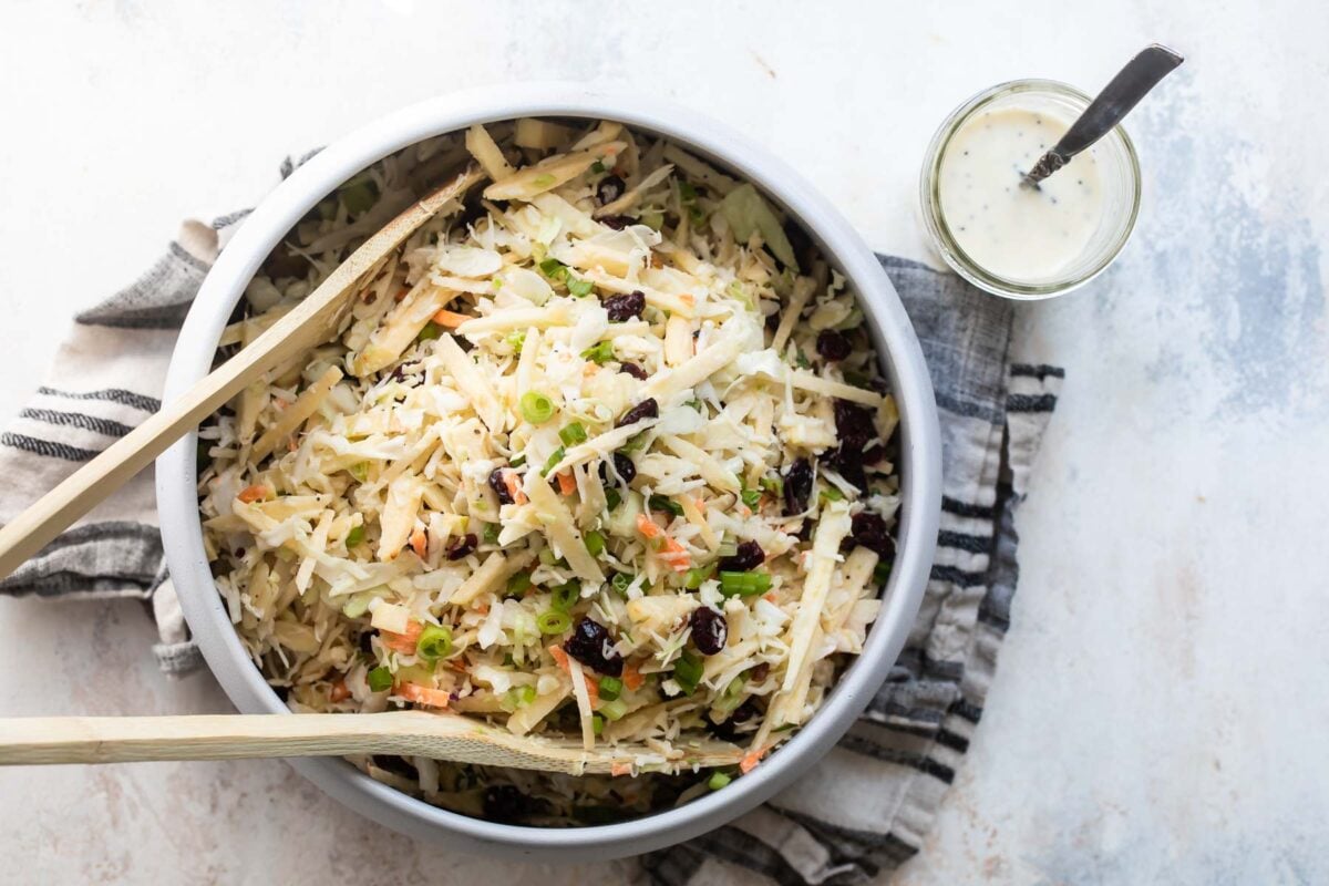 A serving bowl filled with apple coleslaw.