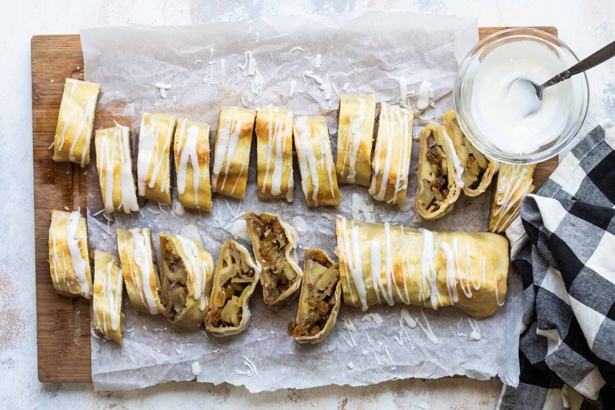 Two apple strudels on a baking sheet.